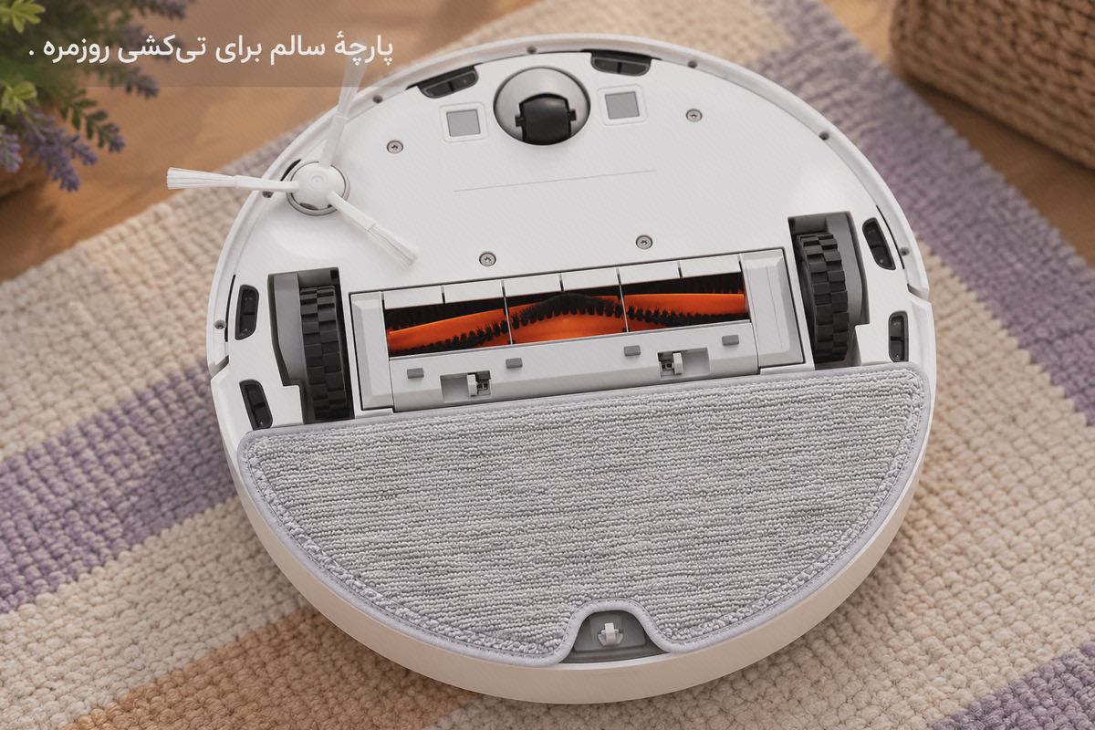پد تی نیم‌دایرهٔ خاکستری با بریدگی مرکزی، نصب‌شده پشت برس نارنجی در زیر جارو سفید Mop Essential