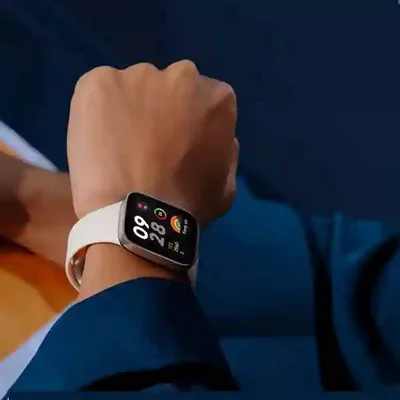 استفاده روزمره Redmi Watch 3 روی مچ دست ساعت Redmi Watch 3 بند کرم روی مچ کاربر با صفحه فعالیت روشن