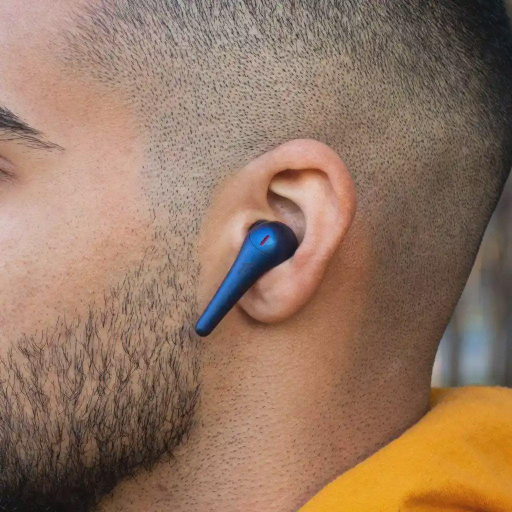 ایرباد آبی ComfoBuds Pro در گوش با ساقه کشیده و جزئیات قرمز بالای بدنه